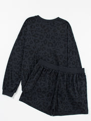 Dark gray leopard print pajama set with crew neck sweatshirt and elastic waist shorts.