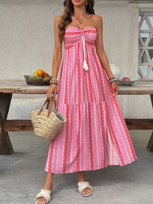 Pink halter neck midi dress with geometric print, drawstring bust, and side slit.
