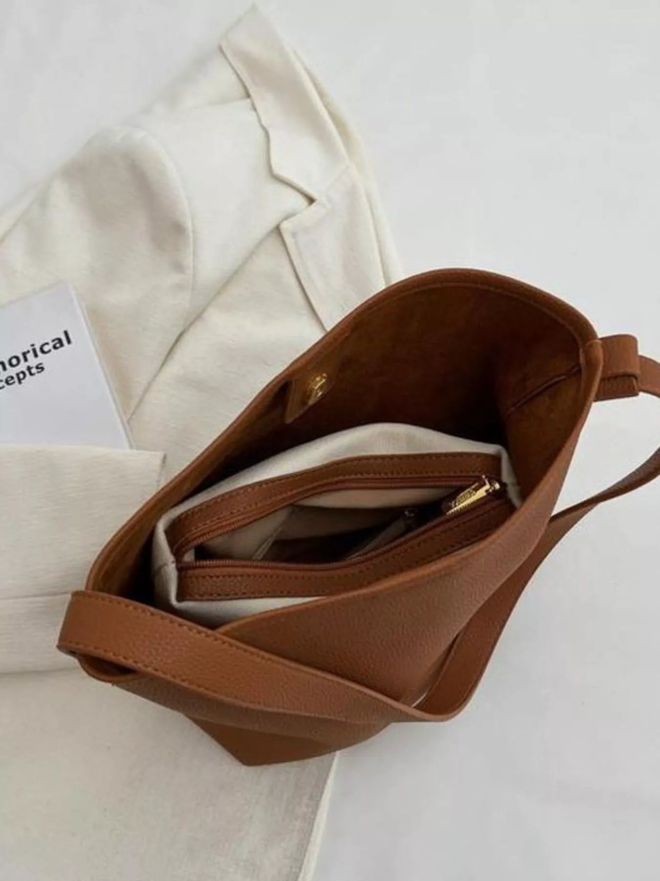 Brown minimalist PU leather shoulder bag with interior zippered pockets