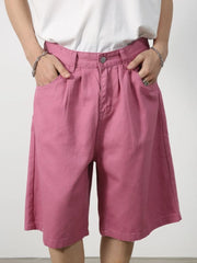 Pleated Bermuda shorts in Moonlit Mauve with a buttoned waist and wide leg.