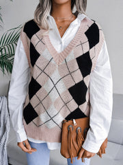Argyle knit v-neck sweater vest in dusty pink, black, and white, styled with a white shirt.