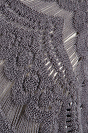 Dark gray acrylic crochet poncho with open knit pattern and fringe detail.
