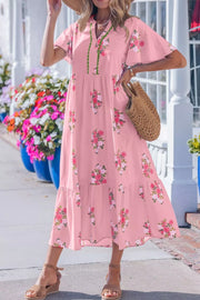 Pink floral midi dress with flutter sleeves and tiered skirt.