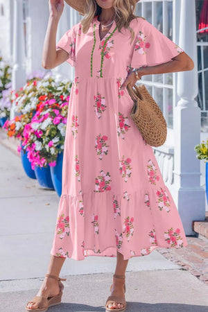 Pink floral midi dress with flutter sleeves and tiered skirt.
