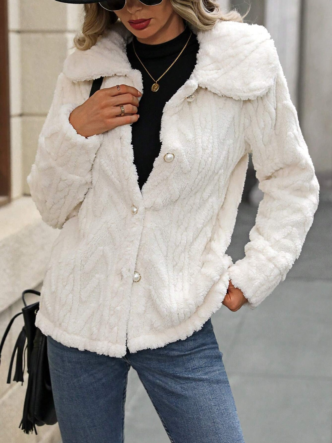 Cream cable knit collar jacket with pearl buttons and textured fabric.