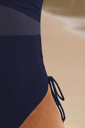 Dark navy one-piece swimsuit with mesh panels and adjustable side ties.
