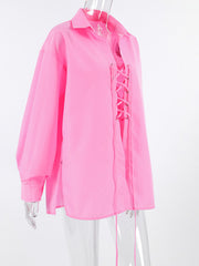 Pink cotton relaxed fit shirt with lace-up front detail and long sleeves.