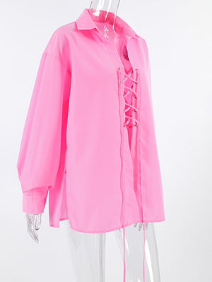 Pink cotton relaxed fit shirt with lace-up front detail and long sleeves.