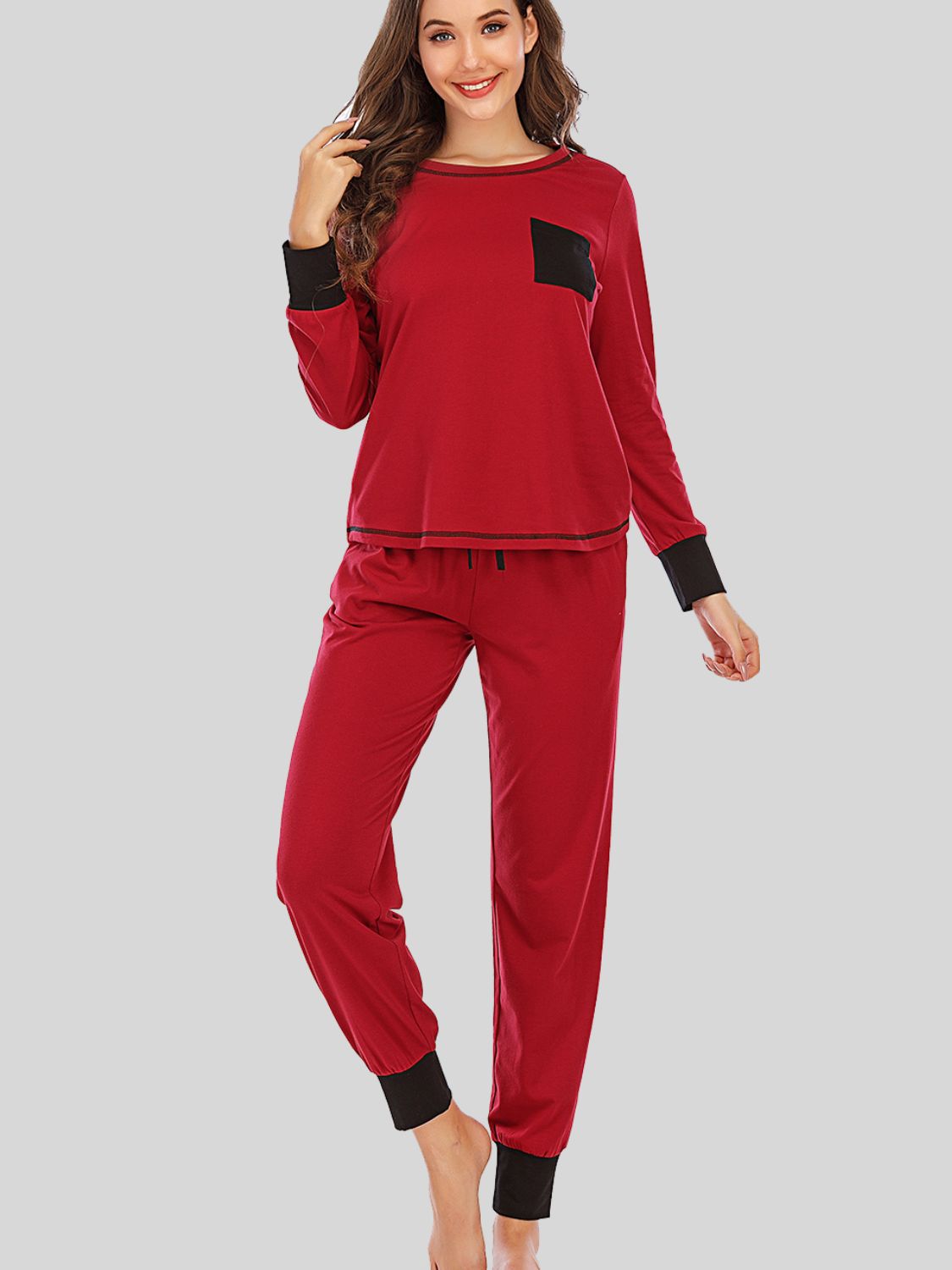 Red loungewear set with black trim on cuffs and pocket, drawstring waist.