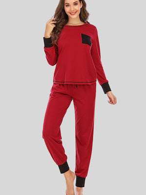 Red loungewear set with black trim on cuffs and pocket, drawstring waist.