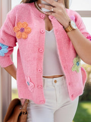 Pink textured knit button-front cardigan with embroidered floral appliques.