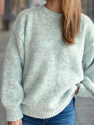 Oversized crewneck sweater in light green textured knit with ribbed cuffs and hem.
