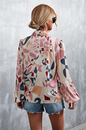 Women's abstract print blouse with balloon sleeves and a pussy bow neckline, in a multi-color pattern.