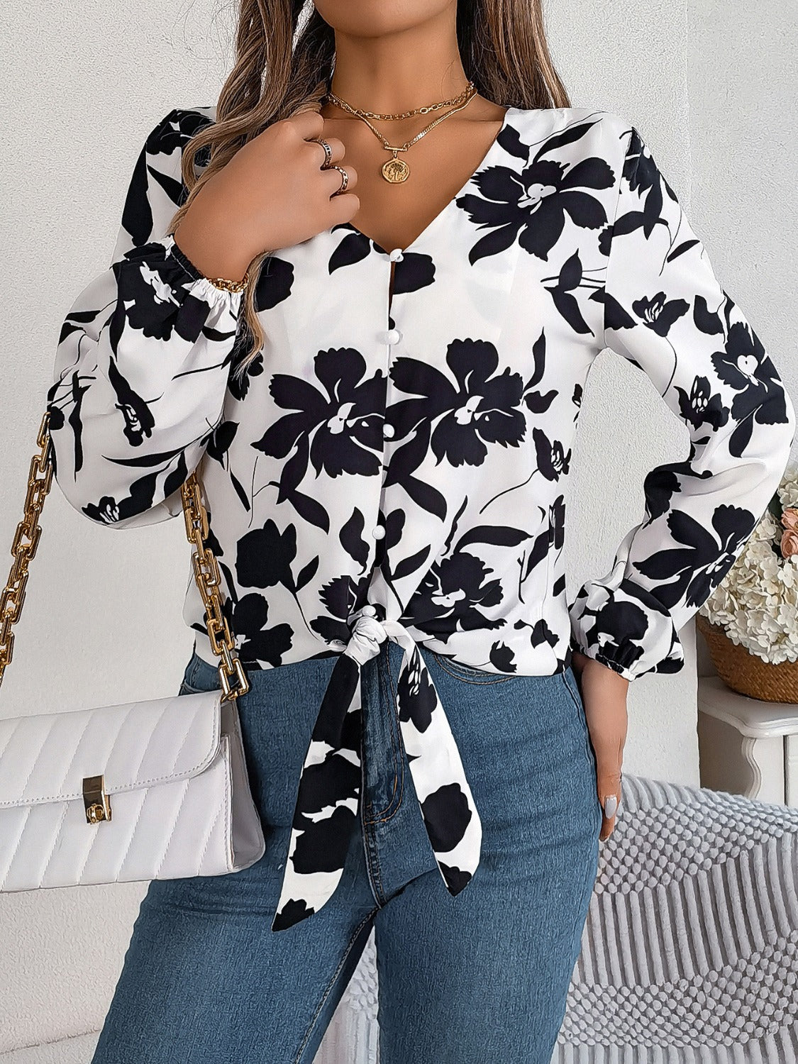 White floral knot-front blouse with ruffled cuffs and button detail