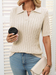 Beige cable knit polo sweater with short sleeves and a collar.