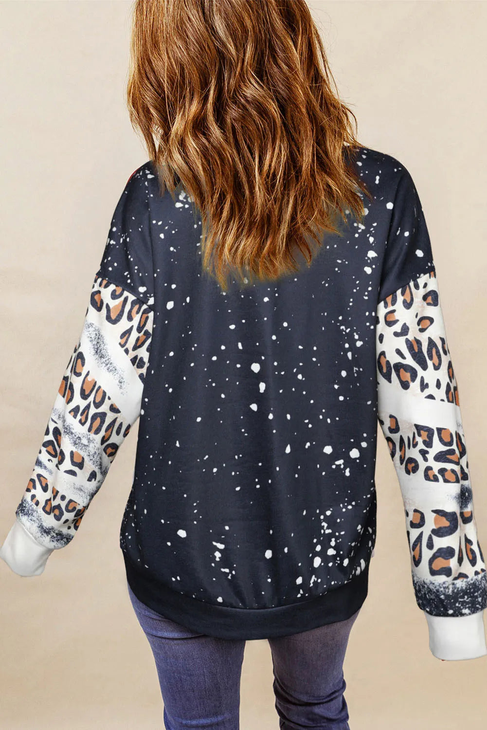 Bleached leopard print sweatshirt with splatter detail and contrast sleeves.