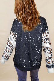 Bleached leopard print sweatshirt with splatter detail and contrast sleeves.