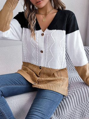 Colorblock cable knit cardigan with button front and V-neck in camel, white, and black acrylic.