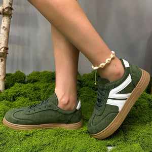 Green suede panel sneakers with white accents and gum soles.