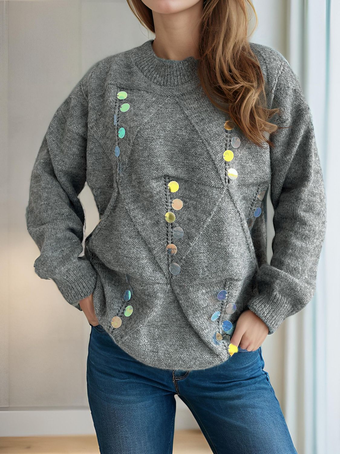 Gray knit sweater with geometric sequin embellishments and crew neck.