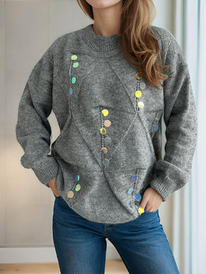 Gray knit sweater with geometric sequin embellishments and crew neck.