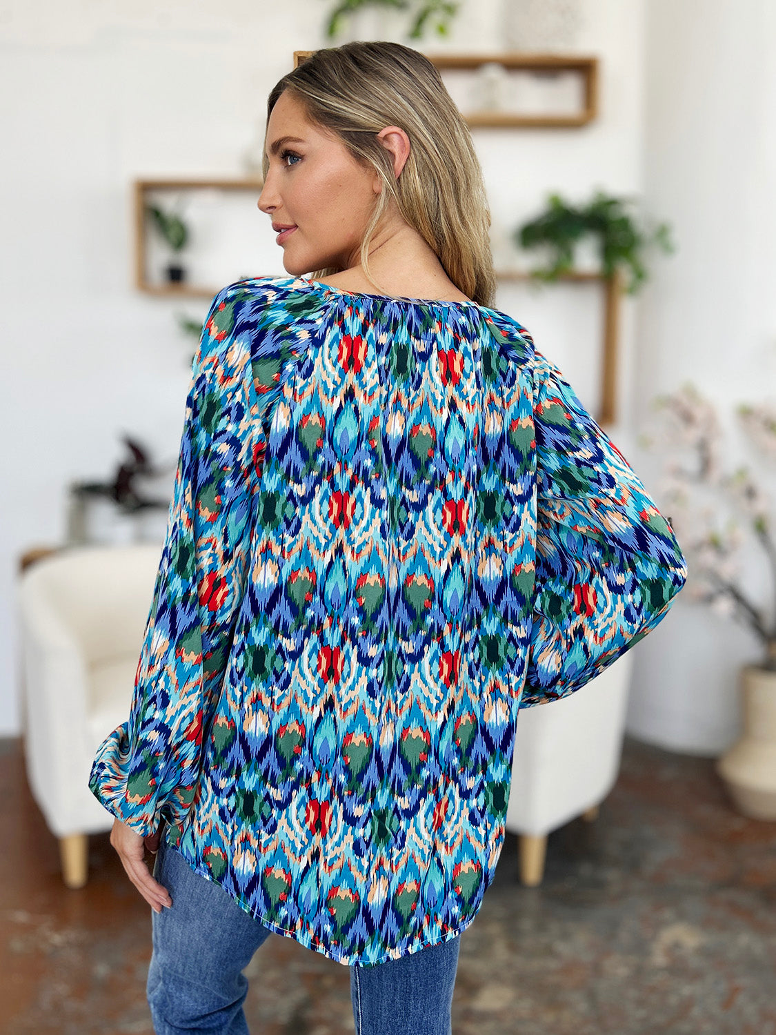 Prismatic ikat blouse with voluminous sleeves in blue and green, featuring a gathered neckline.