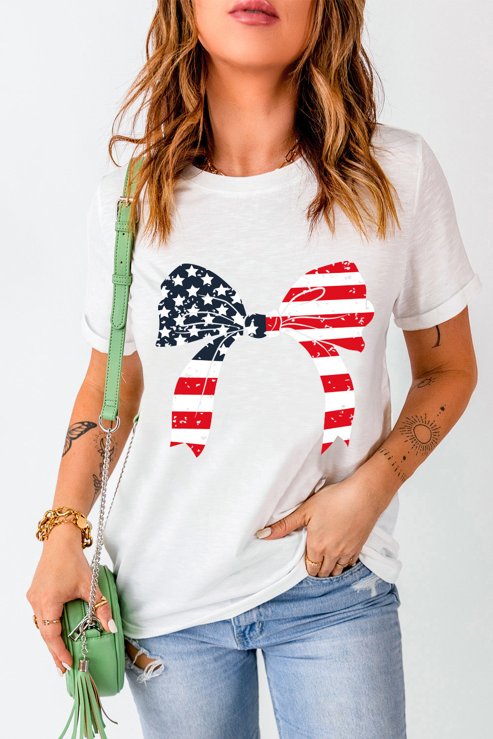 White t-shirt with distressed American flag bow graphic.