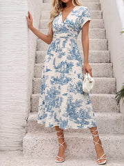 Blue and white toile print midi dress with V-neck, short sleeves, and A-line skirt.