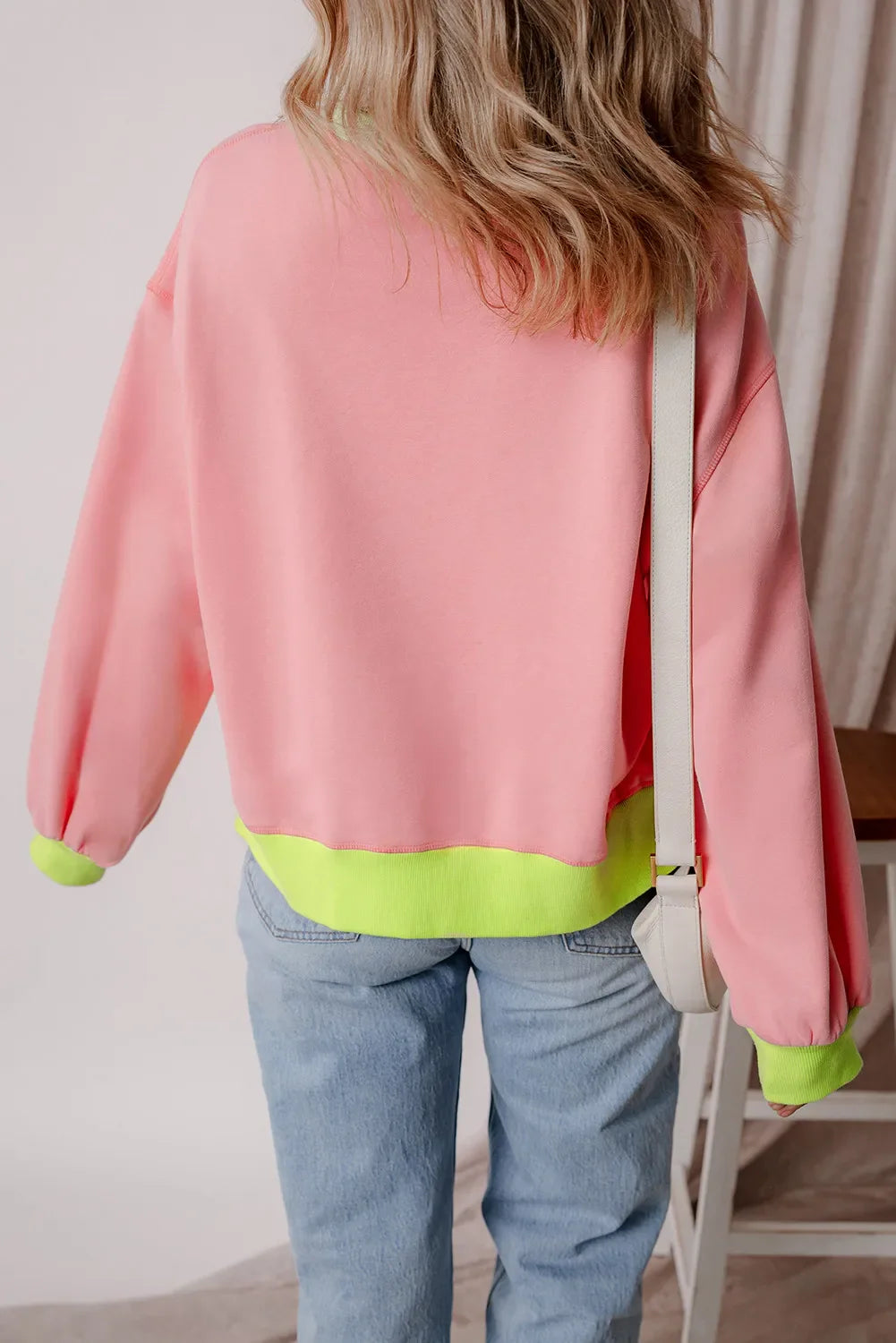 Blush pink sweatshirt with neon trim on cuffs and hem.