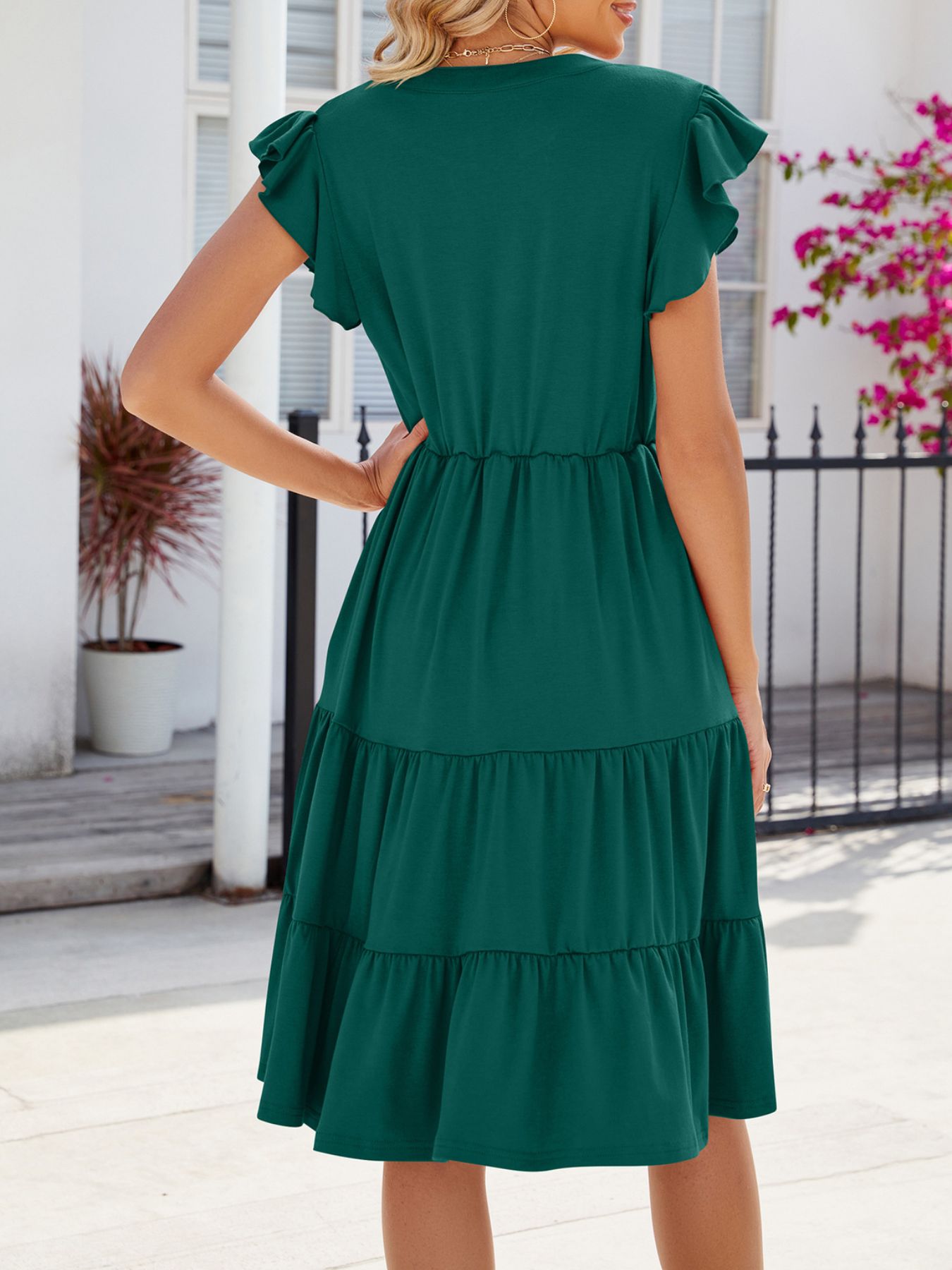 Dark green midi dress with ruffled short sleeves, tiered skirt, and cinched waist.