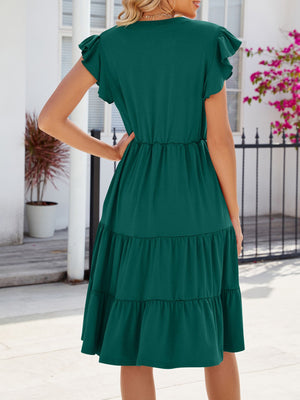 Dark green midi dress with ruffled short sleeves, tiered skirt, and cinched waist.