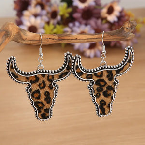 Leopard print bull head drop earrings with silver trim.