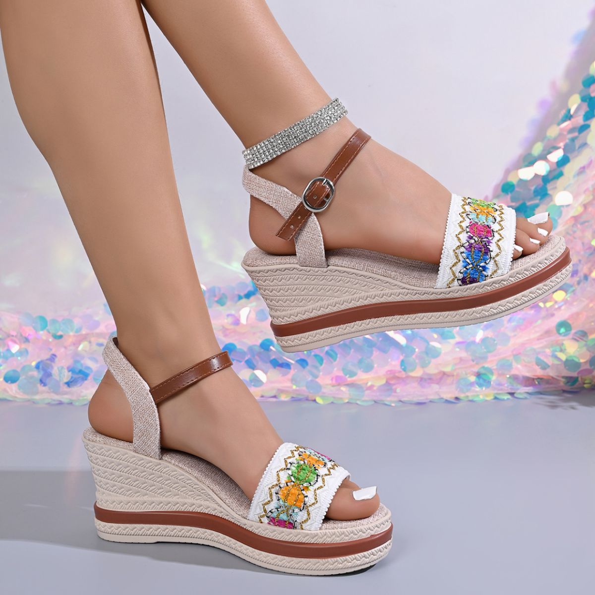 Embroidered floral wedge sandals with adjustable strap and espadrille sole.