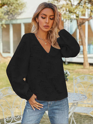 Black textured puff sleeve V-neck blouse with a casual style.