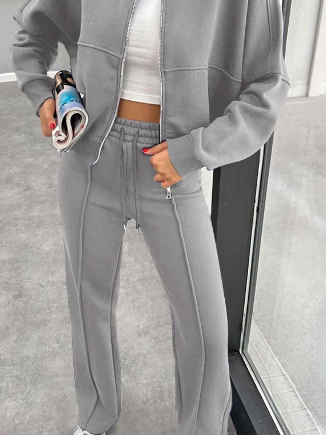 Gray bomber jacket and wide-leg tracksuit with drawstring waist and zippered ankles.
