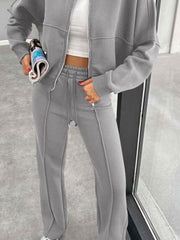 Gray bomber jacket and wide-leg tracksuit with drawstring waist and zippered ankles.