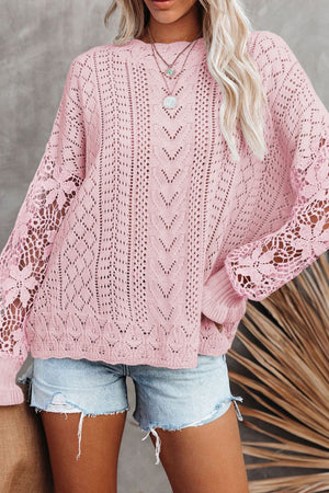 Pink openwork knit sweater with lace sleeves and chevron pattern detail.