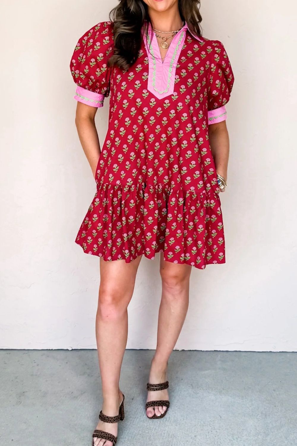 Red floral mini dress with puff sleeves, V-neck, and tiered hem