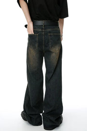 Dark wash wide-leg denim jeans with a distressed, faded look and vertical texture.