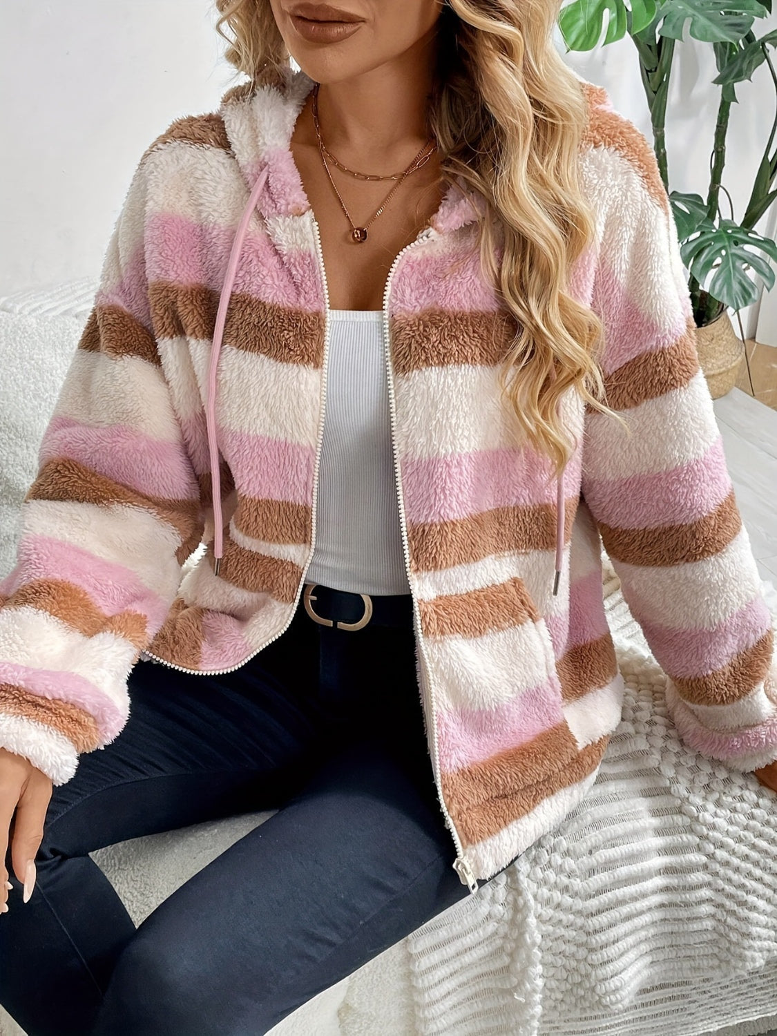 Fuzzy teddy stripe zip-up hoodie in blush pink with a hood and pockets.