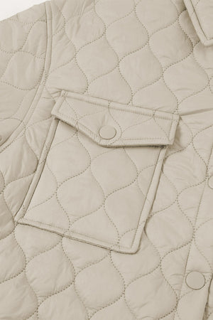 Quilted utility jacket in camel with snap-button chest pocket detail.
