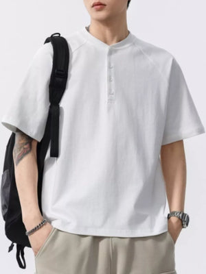 Men's white buttoned henley t-shirt with short sleeves and a band collar.