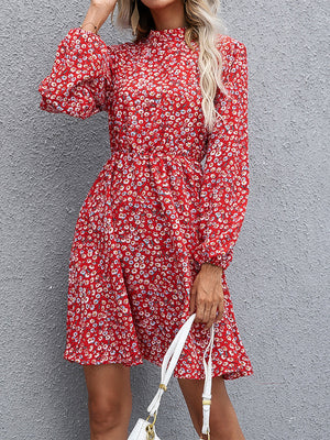 Crimson floral mini dress with gathered sleeves and mock neck.