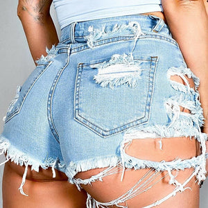 Light wash denim cut-off shorts with extreme distressing and frayed hems.