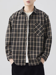 Men's brown and black plaid long sleeve button-down shirt with chest pocket.