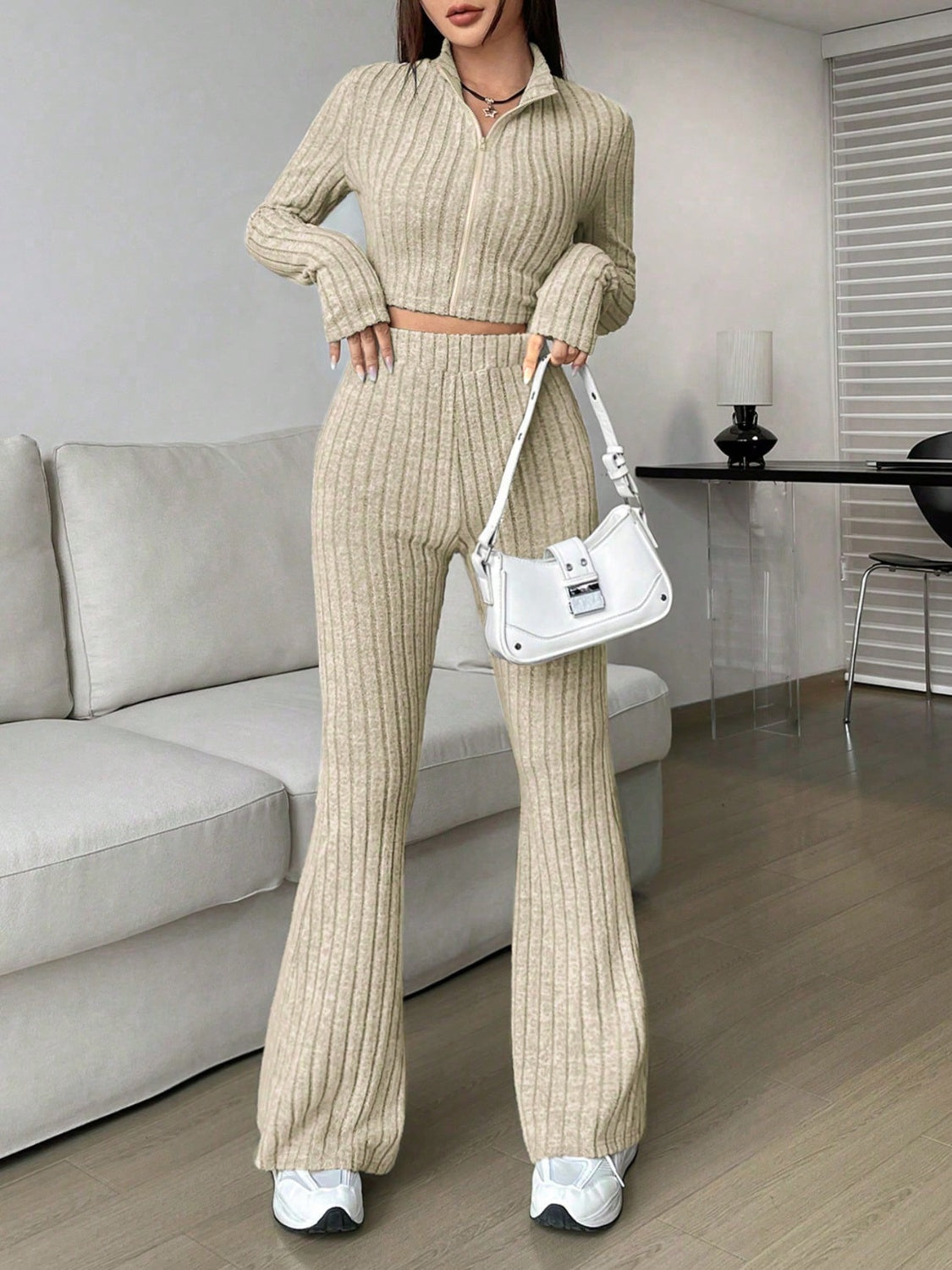 Khaki ribbed knit flare co-ord set with zip-up crop top and high-waisted pants.
