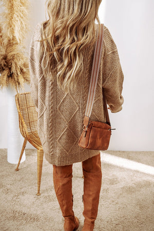Tan cable knit sweater dress with diamond pattern, crew neck, and long sleeves.