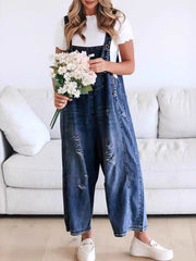Ripped relaxed fit denim overalls in dark blue with wide legs and button closures.