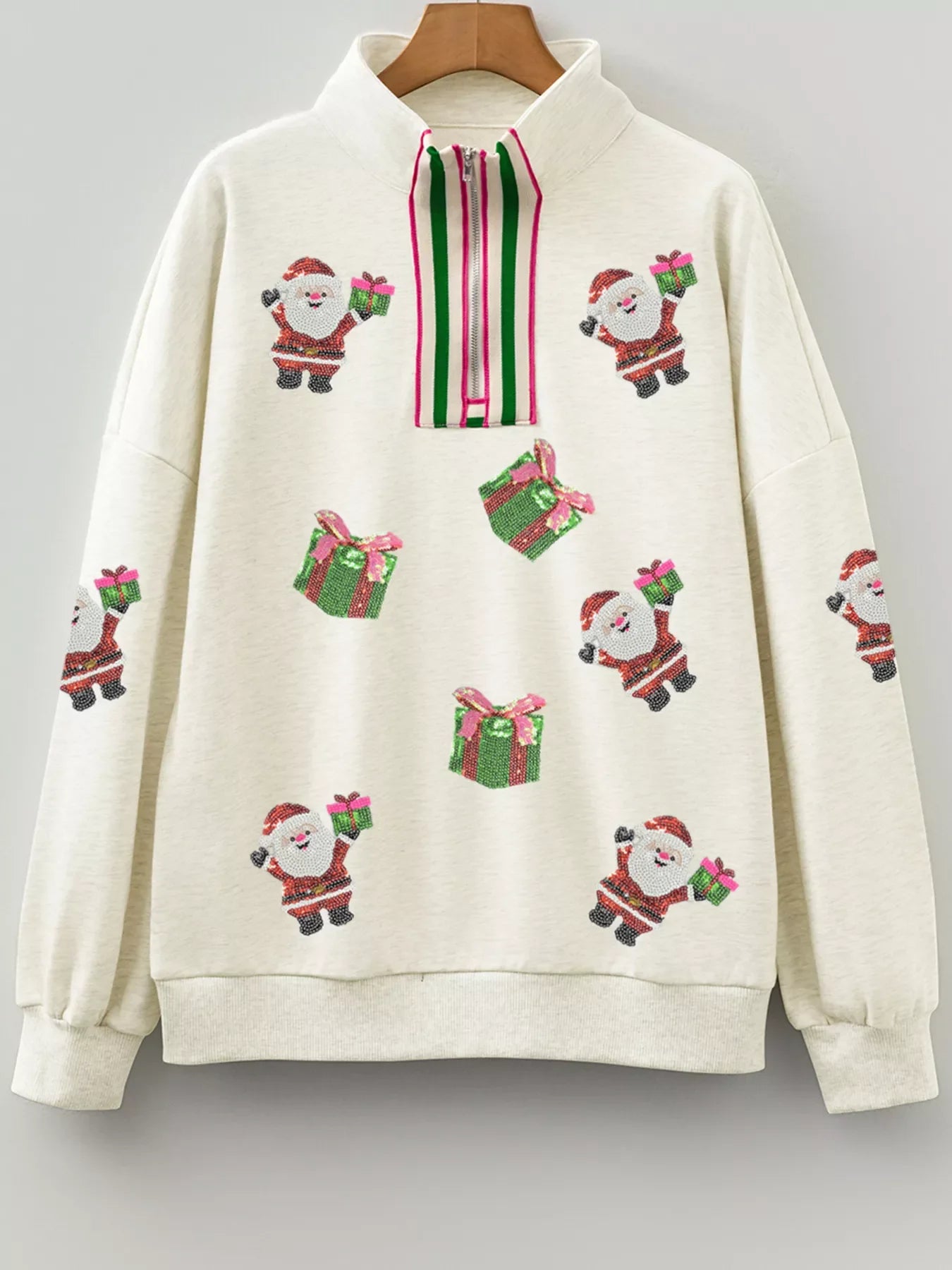 Light gray zip neck sweatshirt with allover sequin Santa and gift pattern.