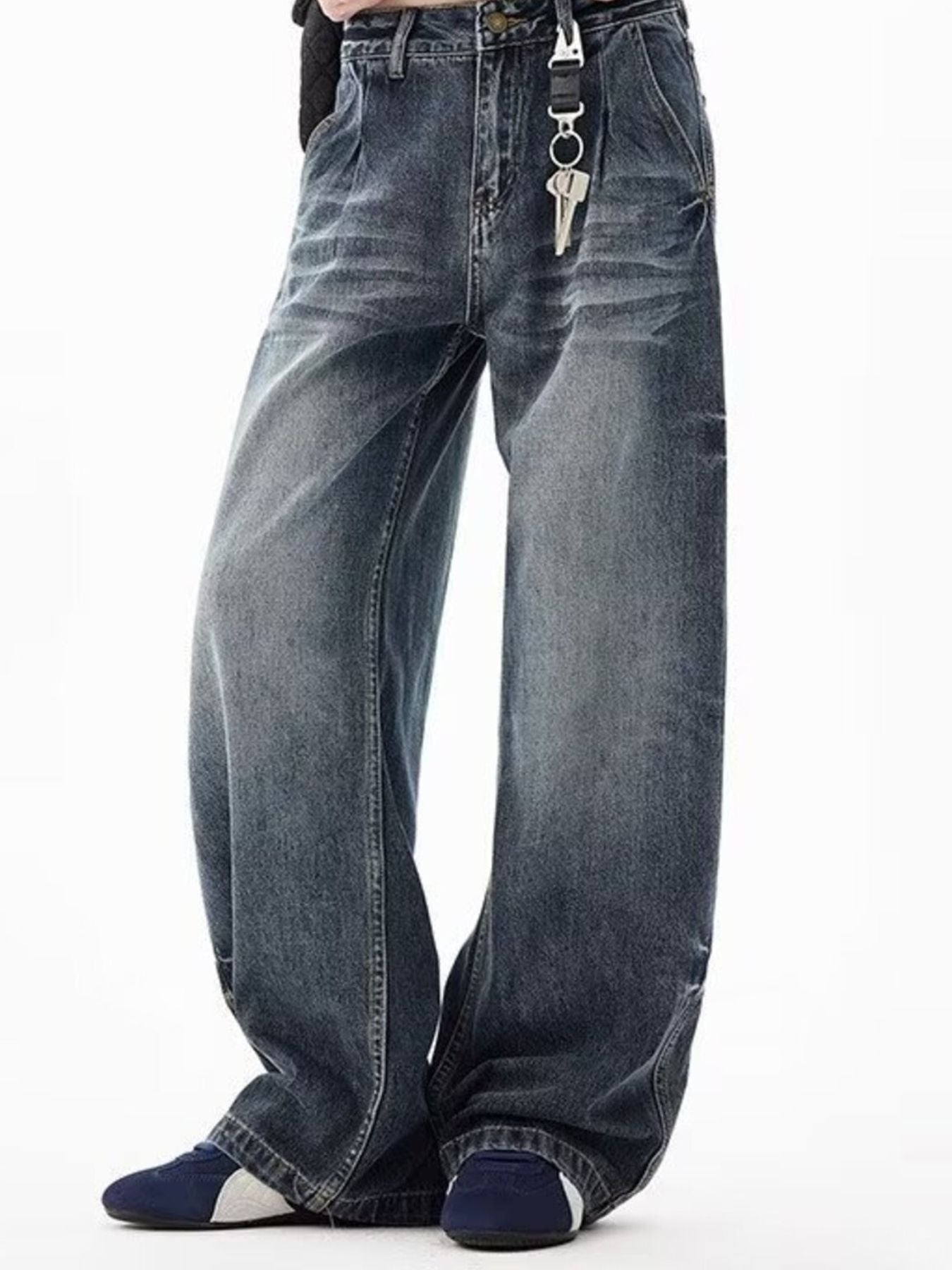 Men's blue denim wide-leg jeans with belt loops and button closure.